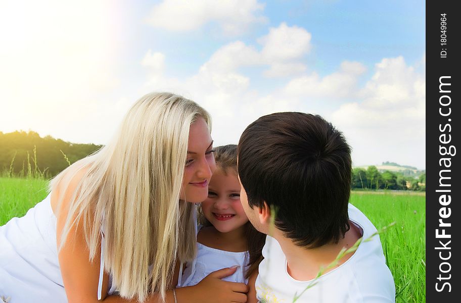 Playful young family on the meadow. Playful young family on the meadow