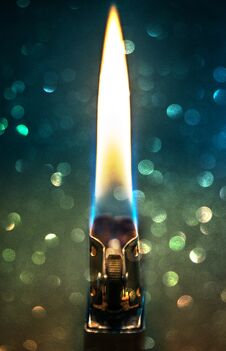 Zippo Lighter Closeup With Flame Bokeh Background Stock Image