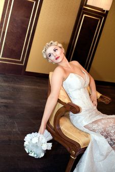 Bride Blond With A Bouquet Sits On A Chair Stock Photos Bride Blond With A Bouquet Sits On A Chair Stock Photos