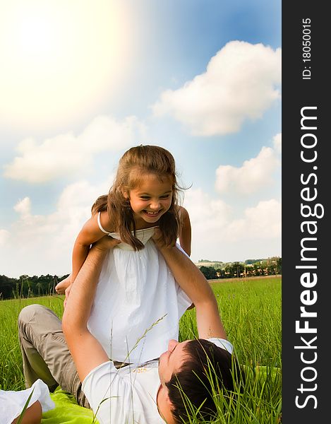 Father and daughter playing in the meadow