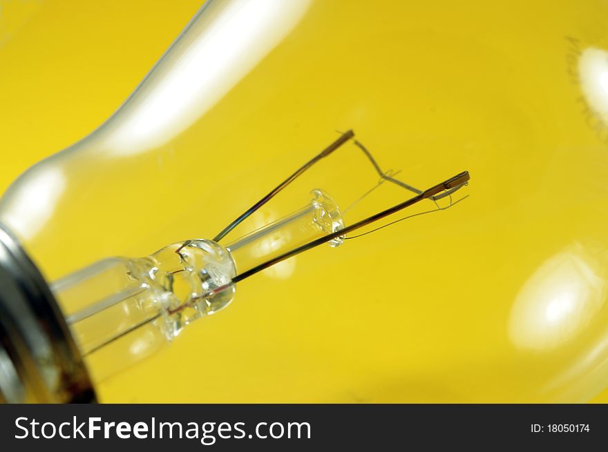 Close up of the lamp spiral on yellow background