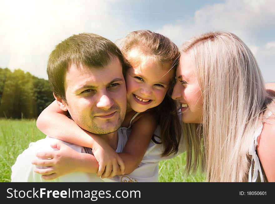 Young playful family on the meadow. Young playful family on the meadow