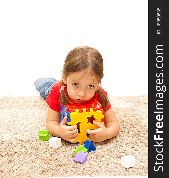 Little beauty girl on a floor with plastic toy. Little beauty girl on a floor with plastic toy