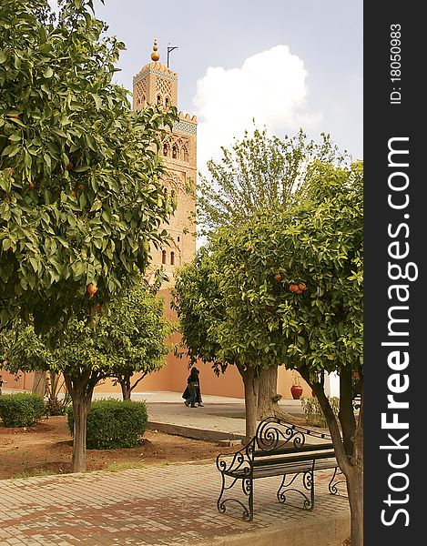 View of Koutoubia mosque tower in Marrakesh from a park with orange trees; Morocco. View of Koutoubia mosque tower in Marrakesh from a park with orange trees; Morocco