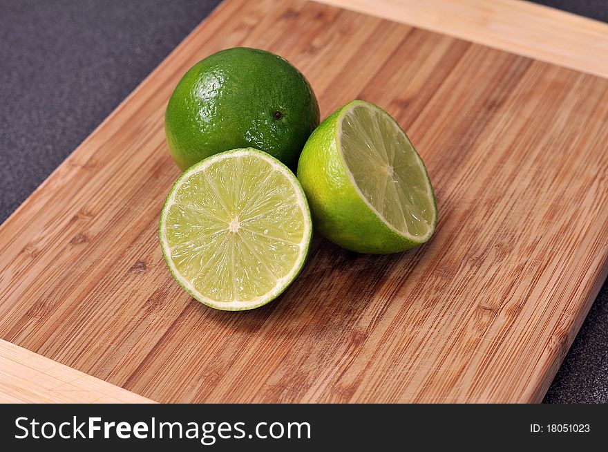 Sliced Lime On A Wooden Plate