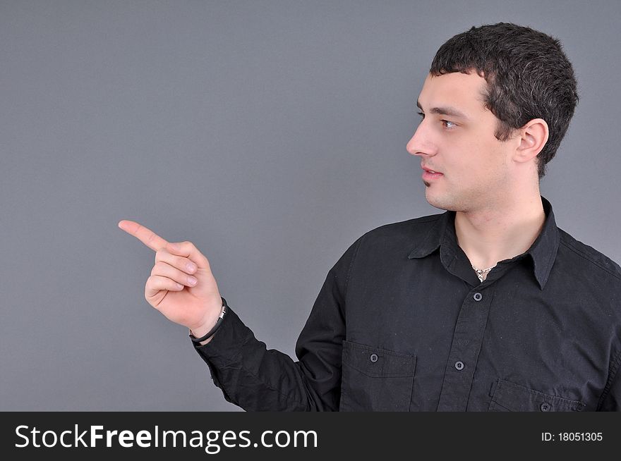 Young attractive man pointing with is finger, isolated on white