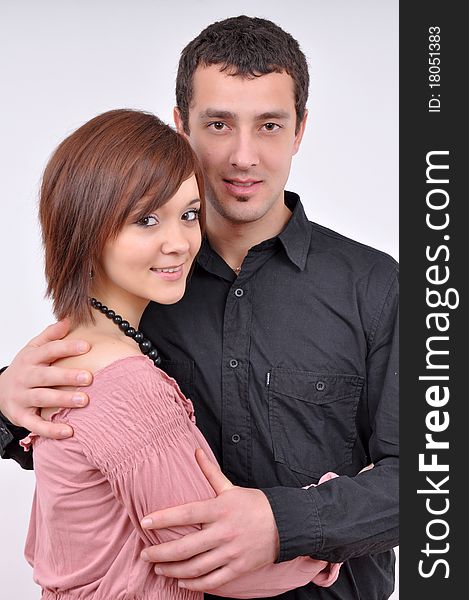 Woman and man posing on a grey background