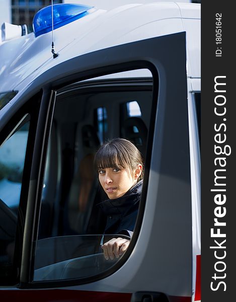 Portrait Of A Female Paramedic Driving Ambulance