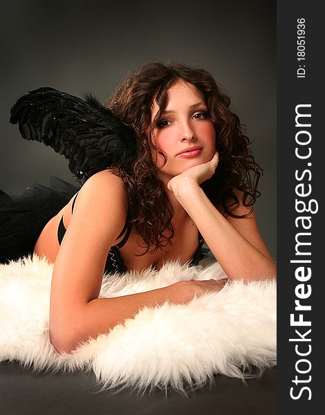 Beautiful young angel with black wings