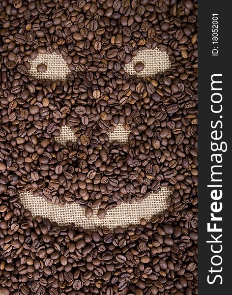 Smiling face made from  grains of coffee