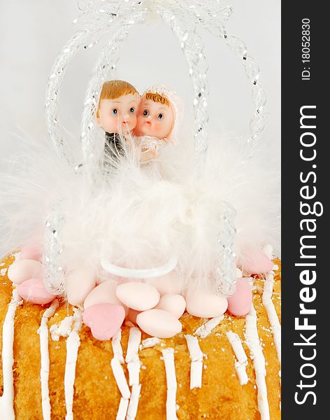Children bride and groom figurines in a feather carriage. Children bride and groom figurines in a feather carriage