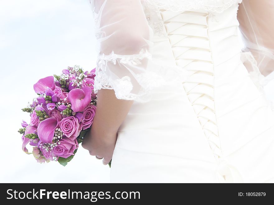 Bride holding wedding bouquet with purple flowers. Bride holding wedding bouquet with purple flowers