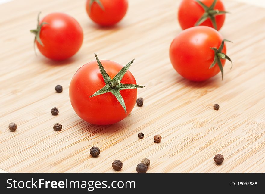 Ripe red cherry tomatoes on a cutting board