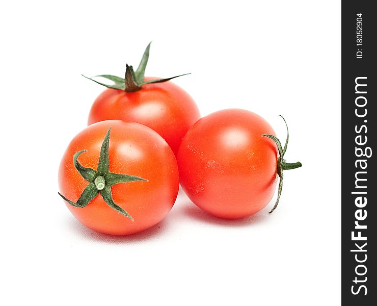 Ripe red cherry tomatoes on white background