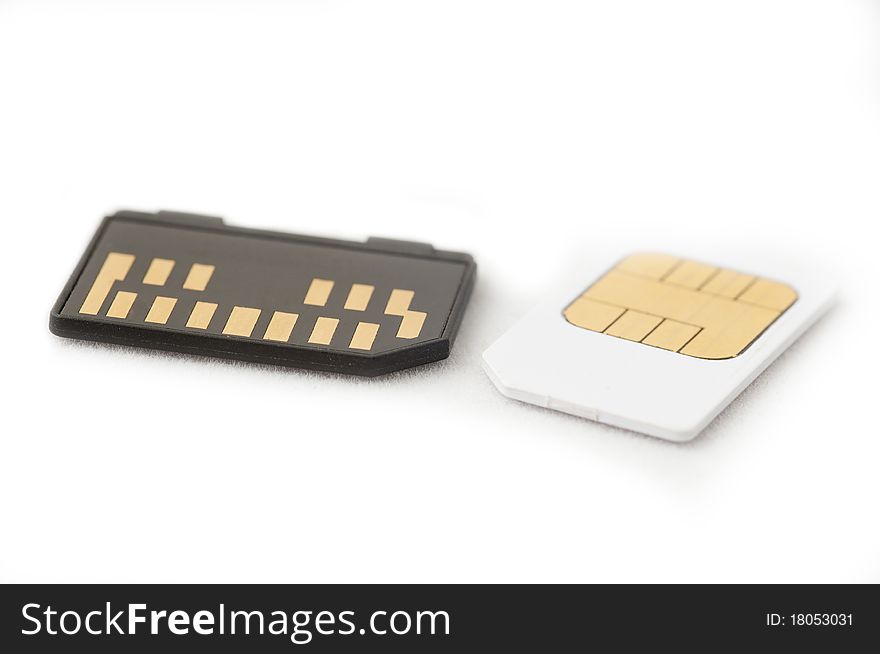 Photo of a black memory card and white sim card. Both used in cellular phones. White background with original shadows. Photo of a black memory card and white sim card. Both used in cellular phones. White background with original shadows...