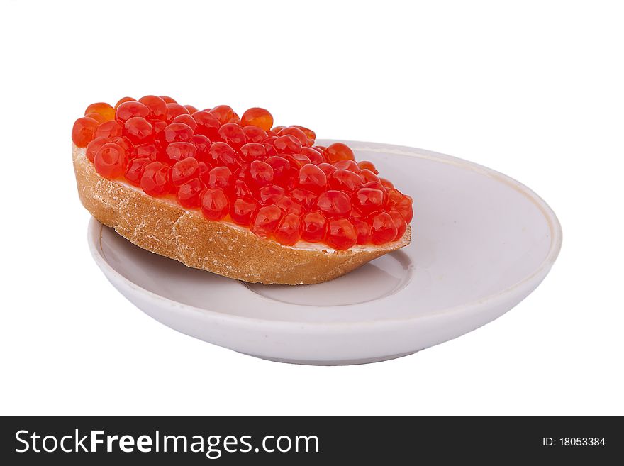 Bread with red caviar on plate on white background