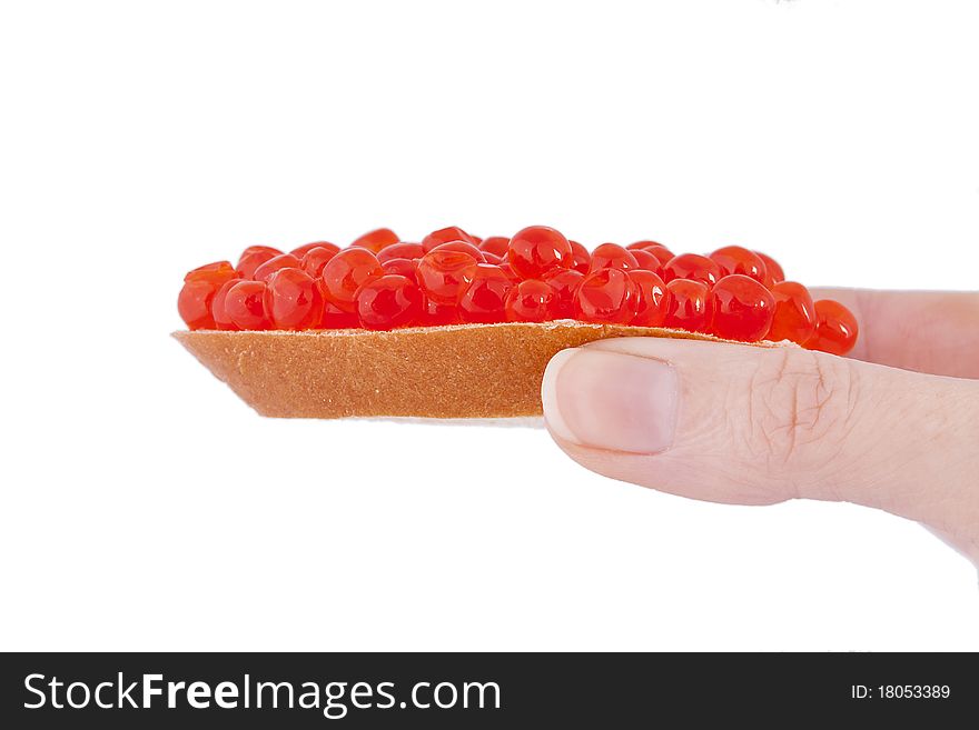Bread and red caviar in the hend on white background