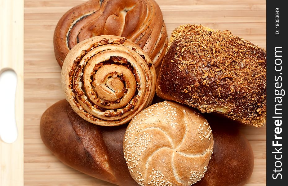 Assortment of baked bread on wood table