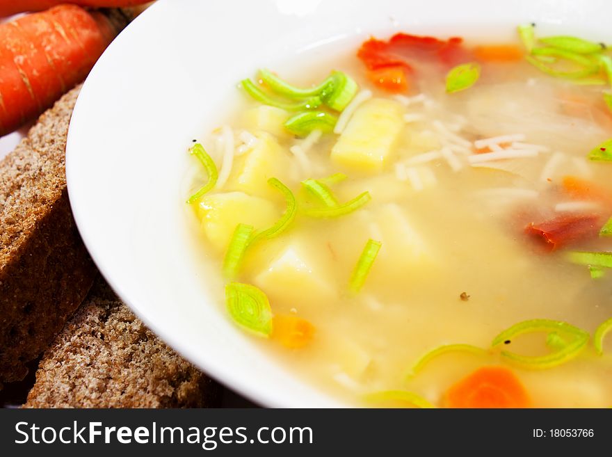Vegetable soup with patatoes and carrots in white bowl. Vegetable soup with patatoes and carrots in white bowl.