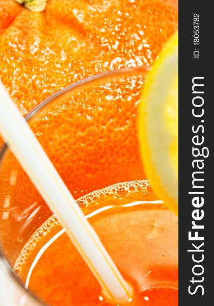 Fresh juice isolated on white background with a lemon on it.