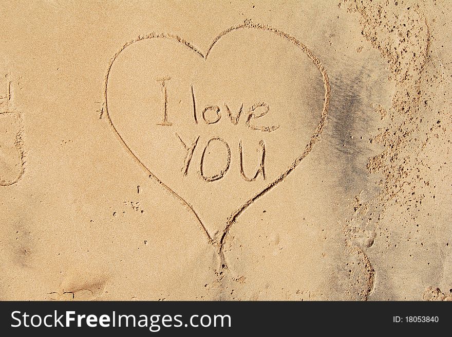 I love you, in the sand, declaration of love. message written in golden sand.