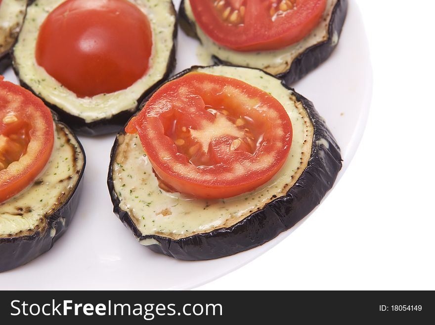 Fried eggplant with tomatoes and garlick sauce on a white background