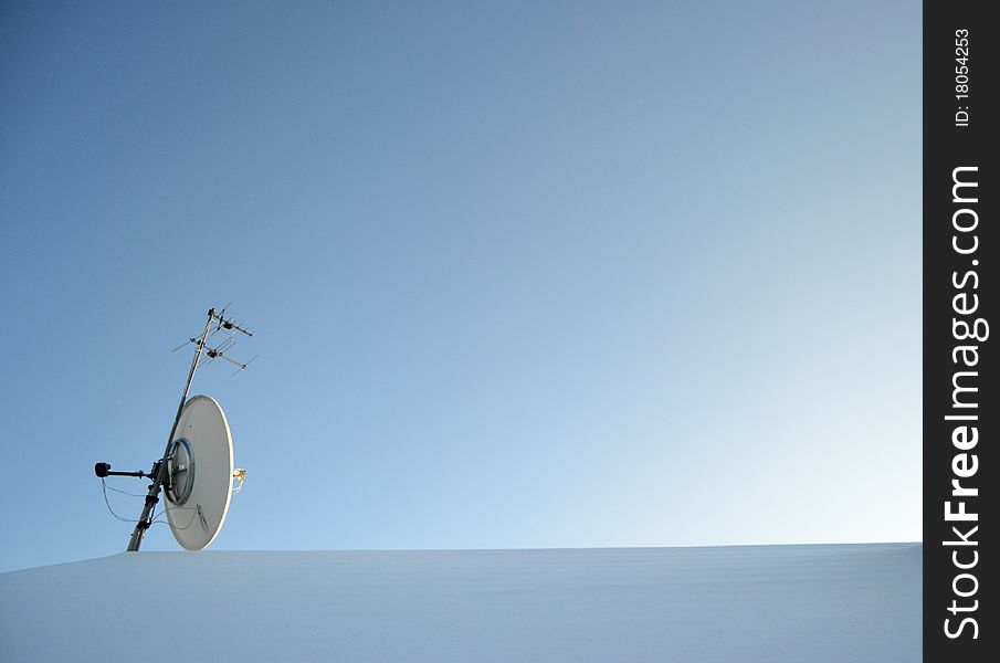 Satellite on roof covered with snow