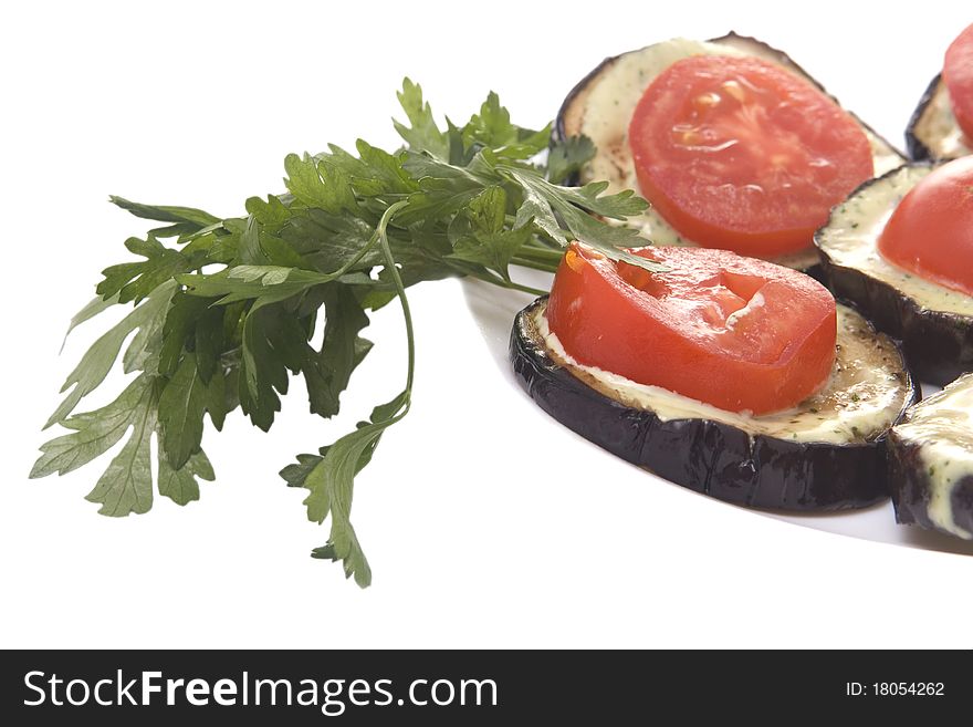 Fried eggplant with tomatoes and garlick sauce on a white background