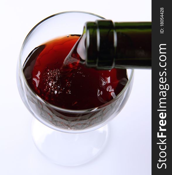 Red wine being poured into a wine glass