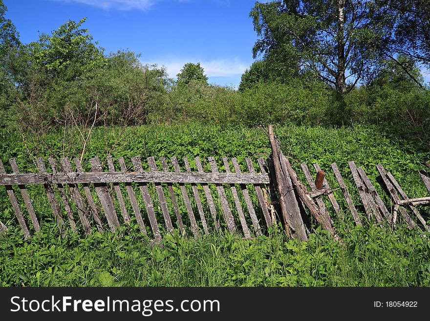 Old wooden fence near farmhouse