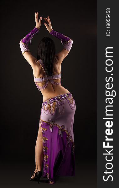 Woman dance in traditional purple arabian costume. Woman dance in traditional purple arabian costume