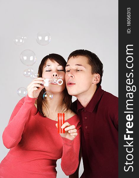 Man and woman blowing out soap bubbles
