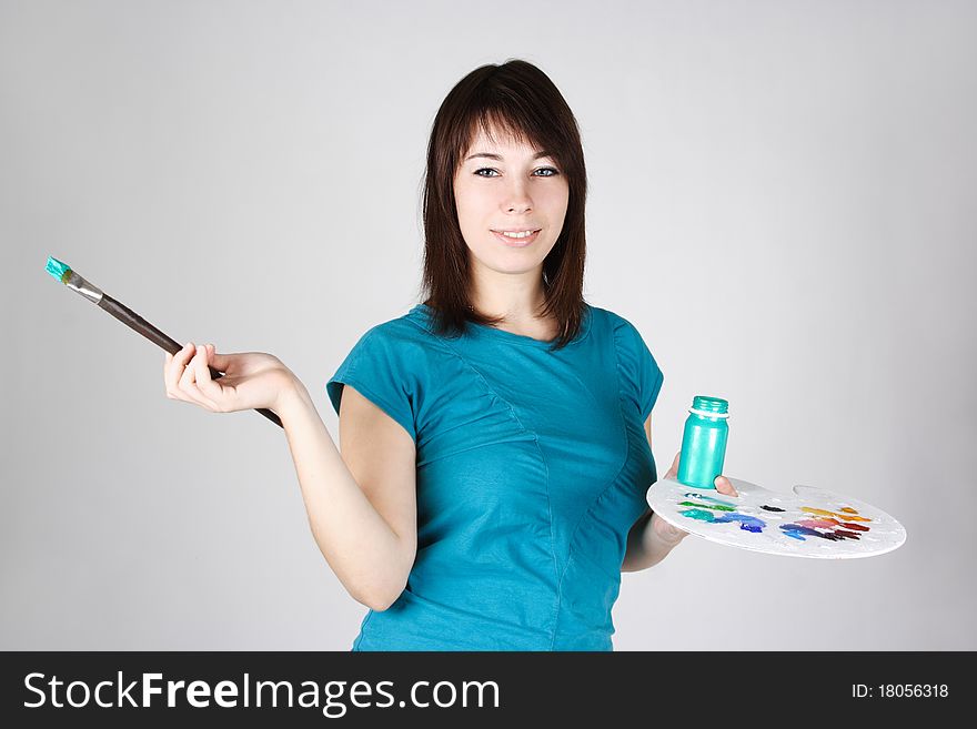 Girl standing and holding brush and palette