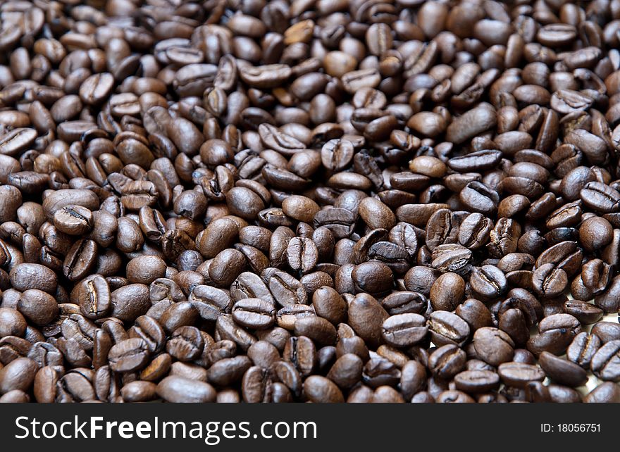Background of small  black roasted coffee beans. Background of small  black roasted coffee beans