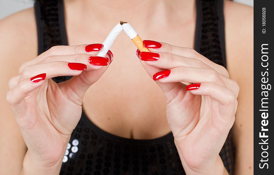 Woman hands breaking a cigarette. Woman hands breaking a cigarette.