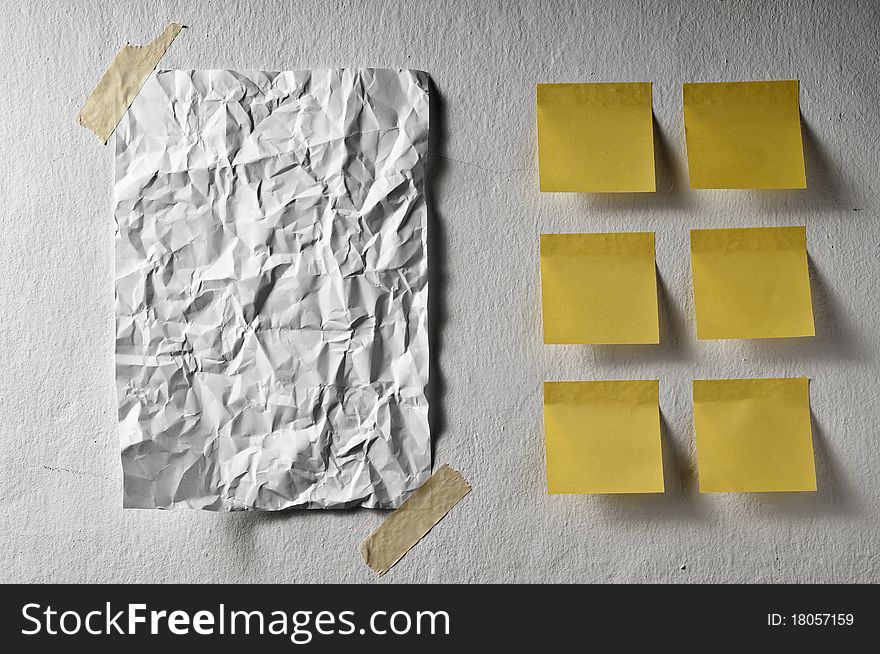 White sheet empty crumpled and yellow post it