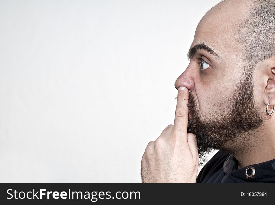 Man with his finger in the nose on white background