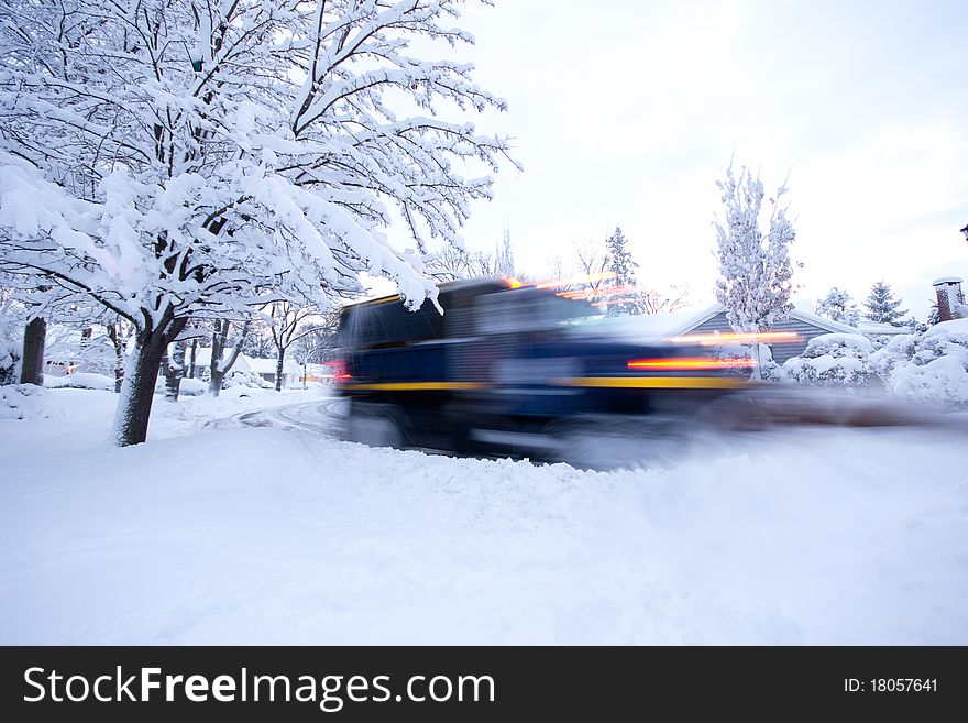 The lights and blur of a snowplow the morning after a heavy snowstorm. The lights and blur of a snowplow the morning after a heavy snowstorm