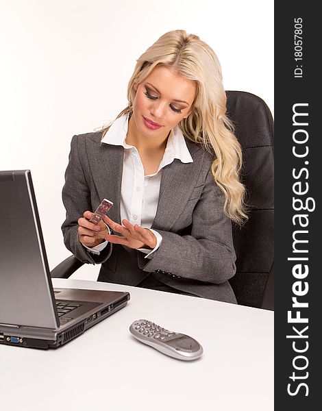 Businesswoman having a break doing her nails at work during the lunch time