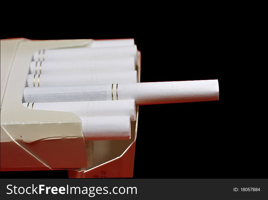 The opened pack of cigarettes on a black background