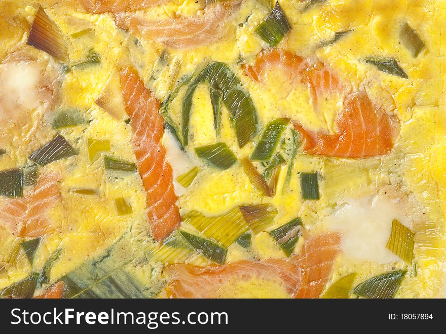 Colorful baked salmon quiche closeup.