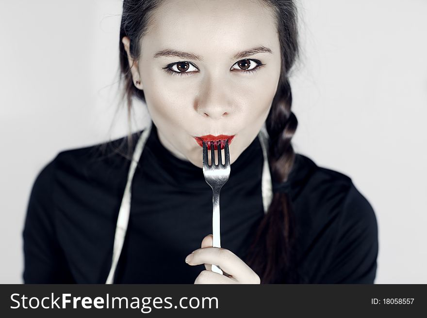 Close up of woman mouth  keeping a fork near the lips. Close up of woman mouth  keeping a fork near the lips