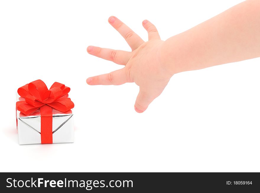 A child's hand taking a gift.  Isolated on white.