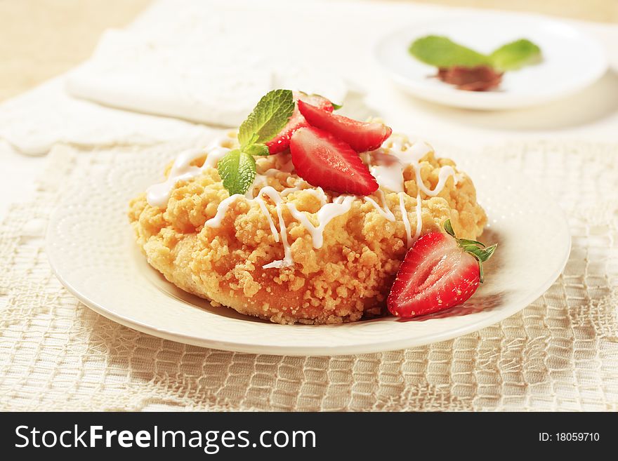 Breakfast pastry with crumb topping served with strawberries. Breakfast pastry with crumb topping served with strawberries