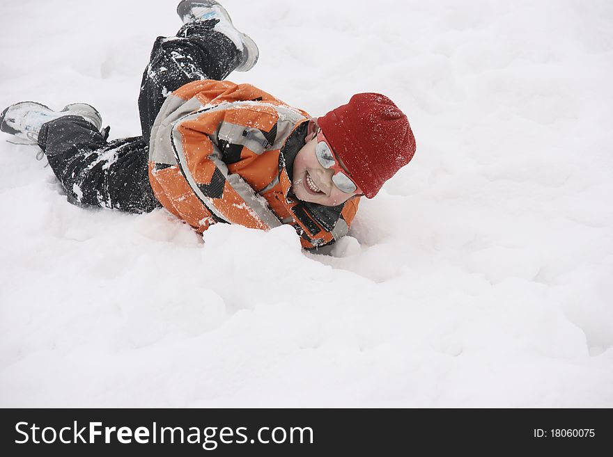 Picture of a little chinese boy lying in heavy snow and having great fun. Picture of a little chinese boy lying in heavy snow and having great fun