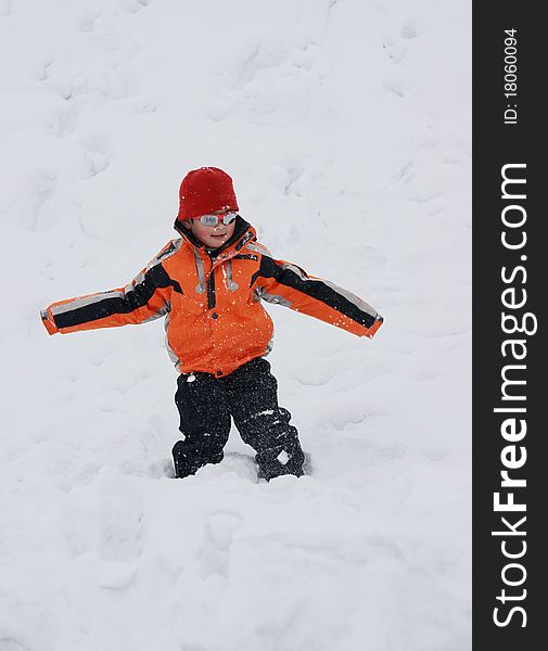 Picture of a little chinese boy lying in heavy snow and having great fun. Picture of a little chinese boy lying in heavy snow and having great fun