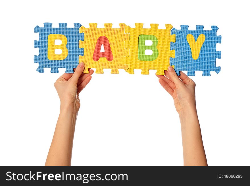 Teacher holding in the hand the amusing colored educational puzzles with the word baby