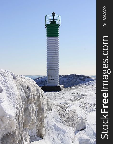 Green and white lighthouse in winter. Green and white lighthouse in winter