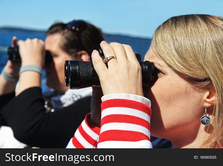 Young woman looking through binoculars. Young woman looking through binoculars