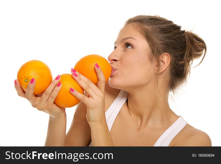 Young woman with three oranges isolated in white
